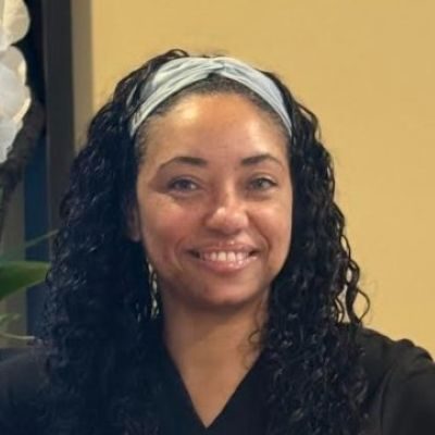 Neuropathy Louisville KY Tatisha Meet the Team Tatisha headshot smiling and wearing a black top.